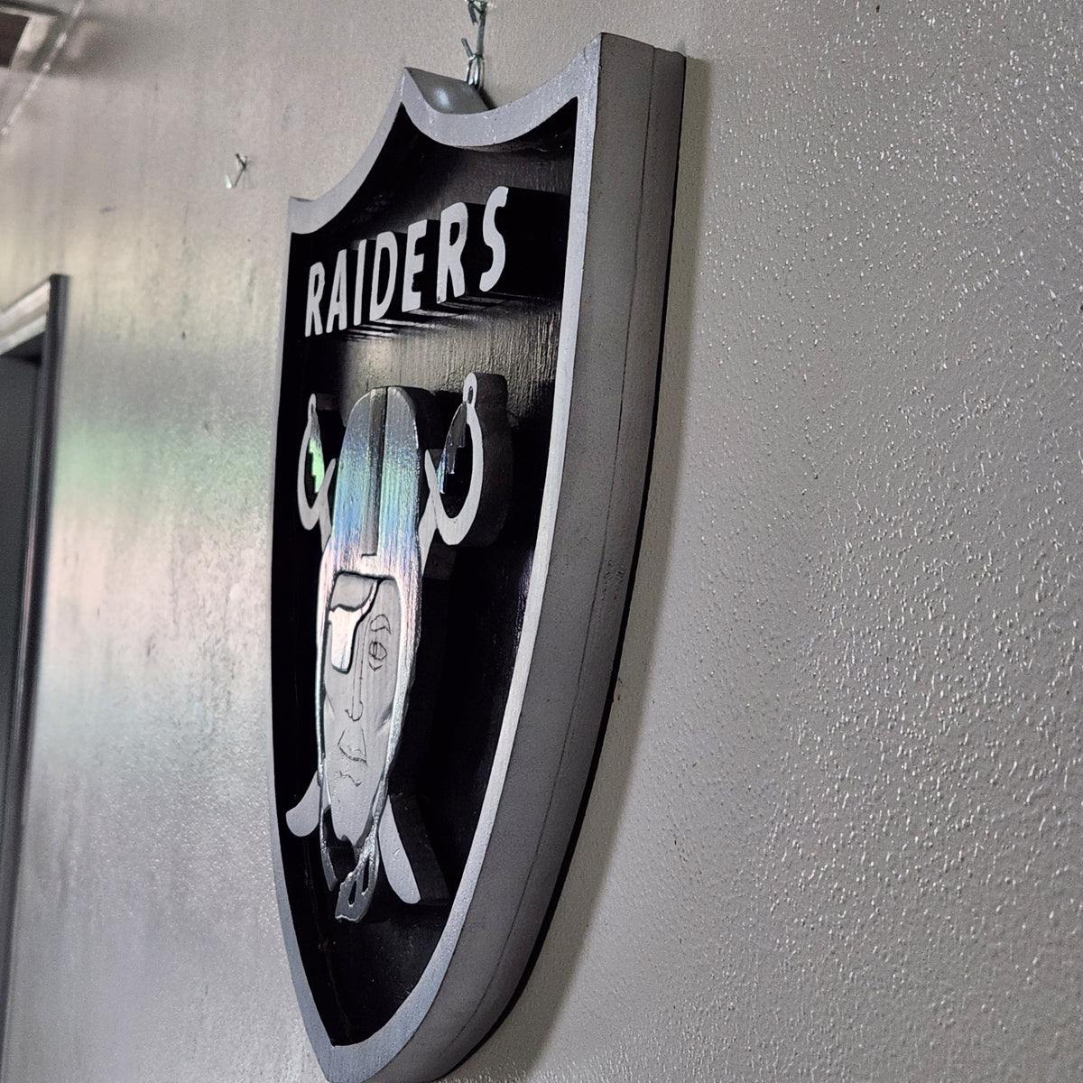Handcrafted Raiders-Inspired Wood Wall Art – Black & Silver 18x17" Shield Sign