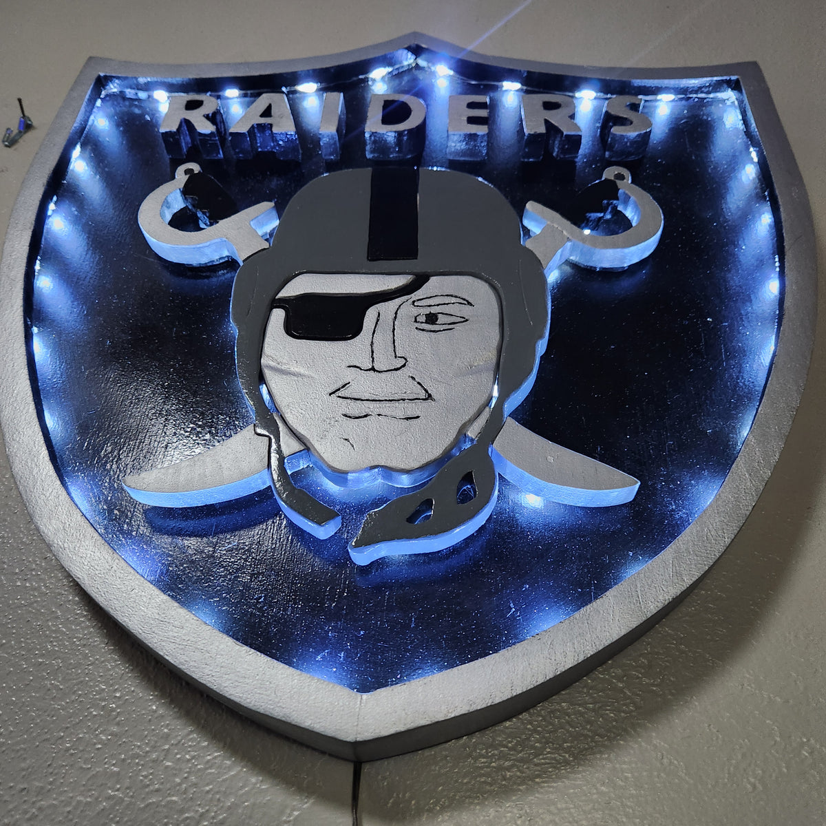 Handcrafted Raiders-Inspired Wood Wall Art – Black & Silver 18x17" Shield Sign