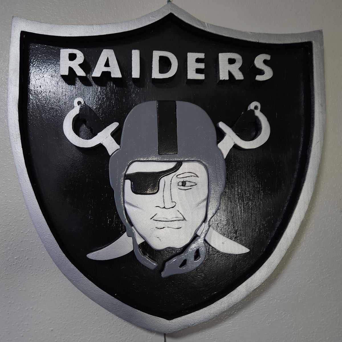 Handcrafted Raiders-Inspired Wood Wall Art – Black & Silver 18x17" Shield Sign